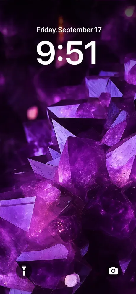 Purple glowing crystal and gemstone wallpaper with bokeh effects for iPhone lock screen aesthetic